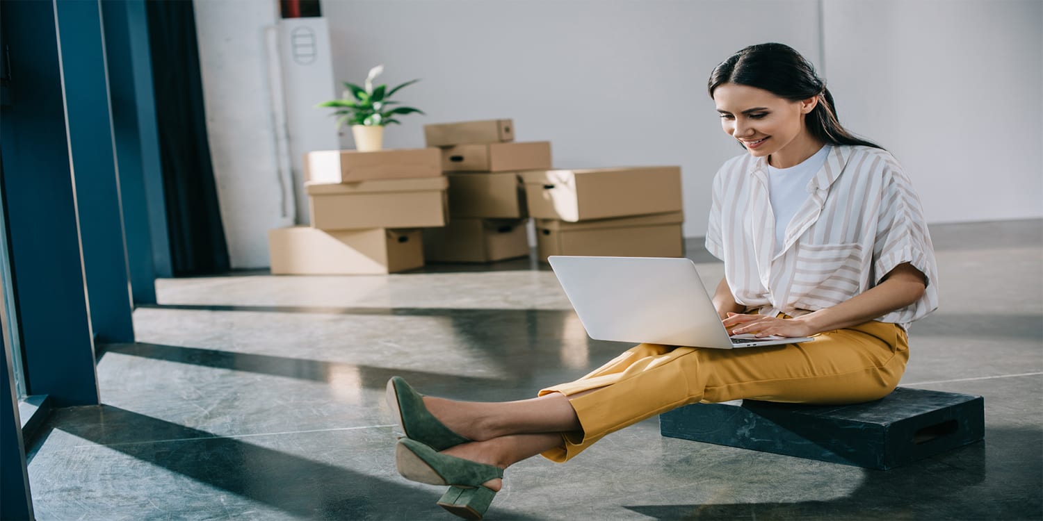 Young woman with home office packed up for job relocation.